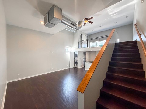 A staircase with a wooden handrail leads up to a second floor.