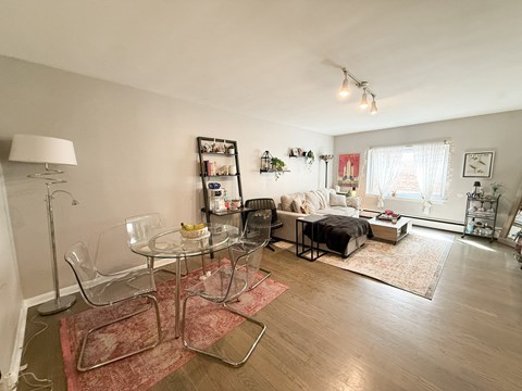 A living room with a glass table and chairs.