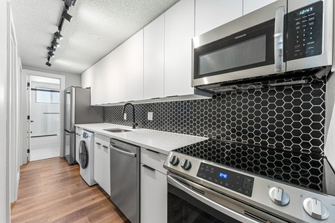 a kitchen with a stove top oven and a microwave