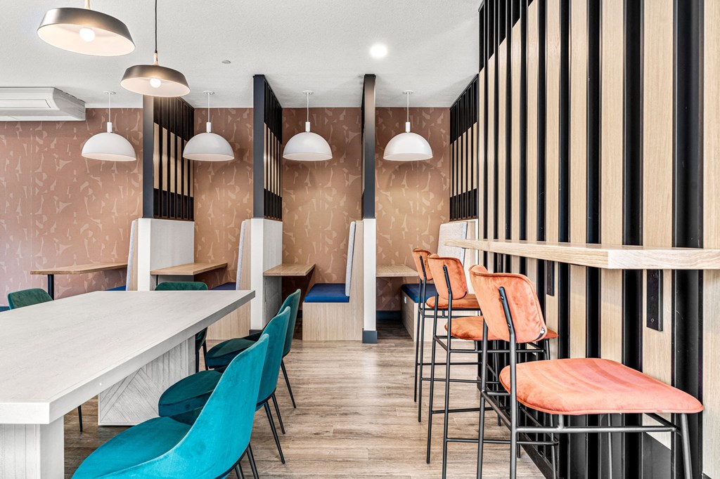 a dining room with tables and chairs and a striped wall