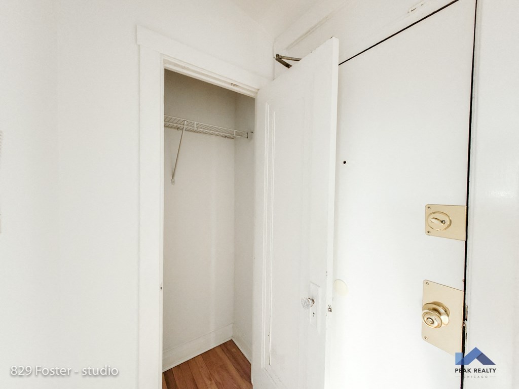 a closet with a mirror and a door to a closet