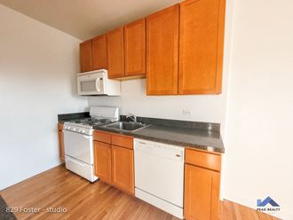 a kitchen with white appliances and wooden cabinets