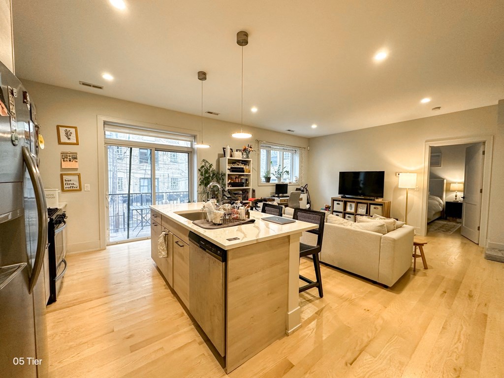 a kitchen and living room with a couch and a tv
