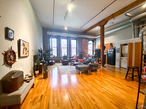 A living room with wooden floors and furniture.