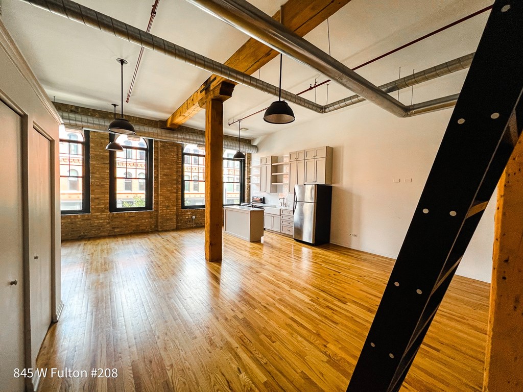 A large open space with wooden floors and exposed ceiling beams.