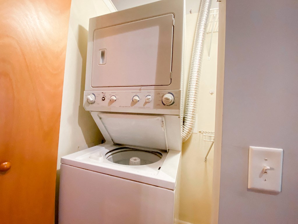 a washer and dryer in a small room with a door
