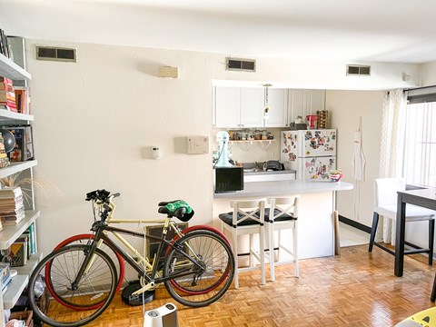 a bike parked in a living room next to a kitchen