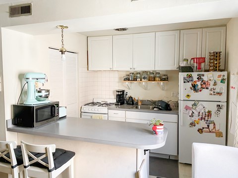 a small kitchen with a counter and a refrigerator