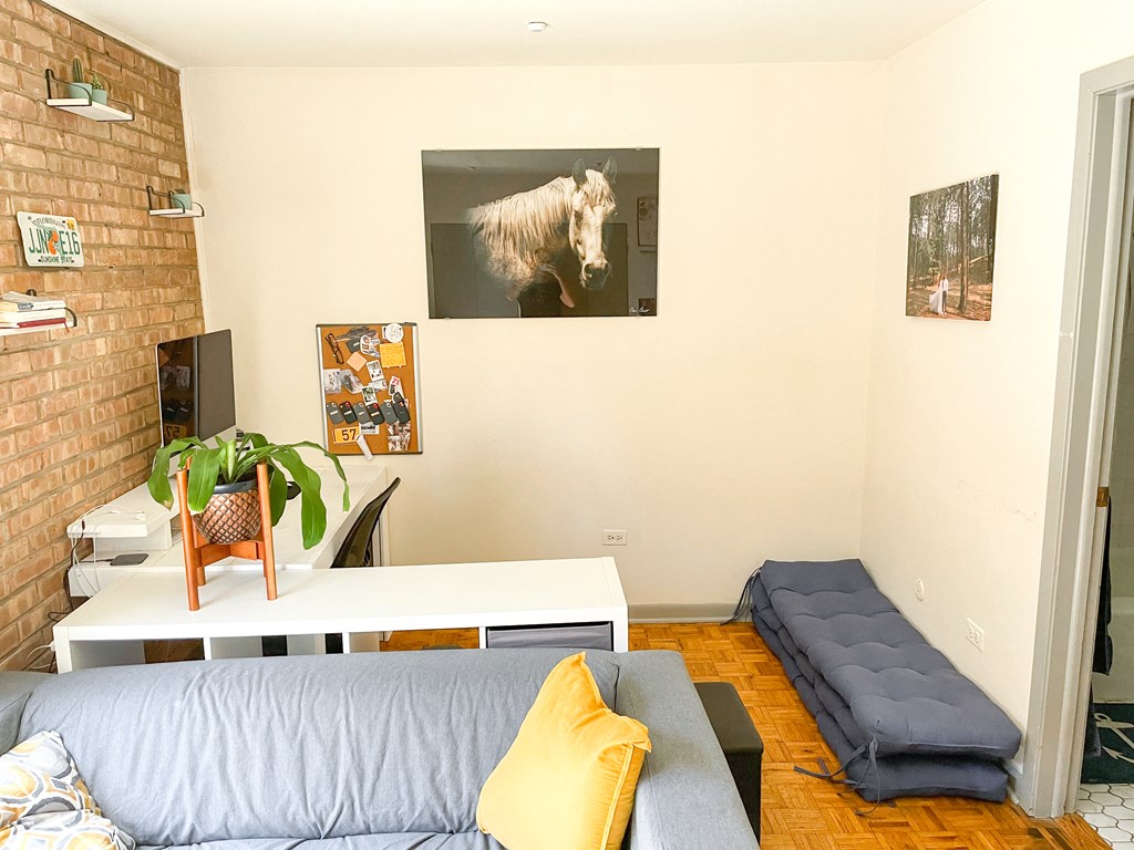 a living room with a couch and a table and a desk
