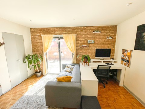 a living room with a couch and a desk with a computer