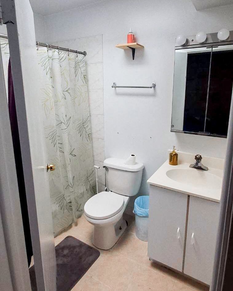 a bathroom with a toilet and a sink and a shower
