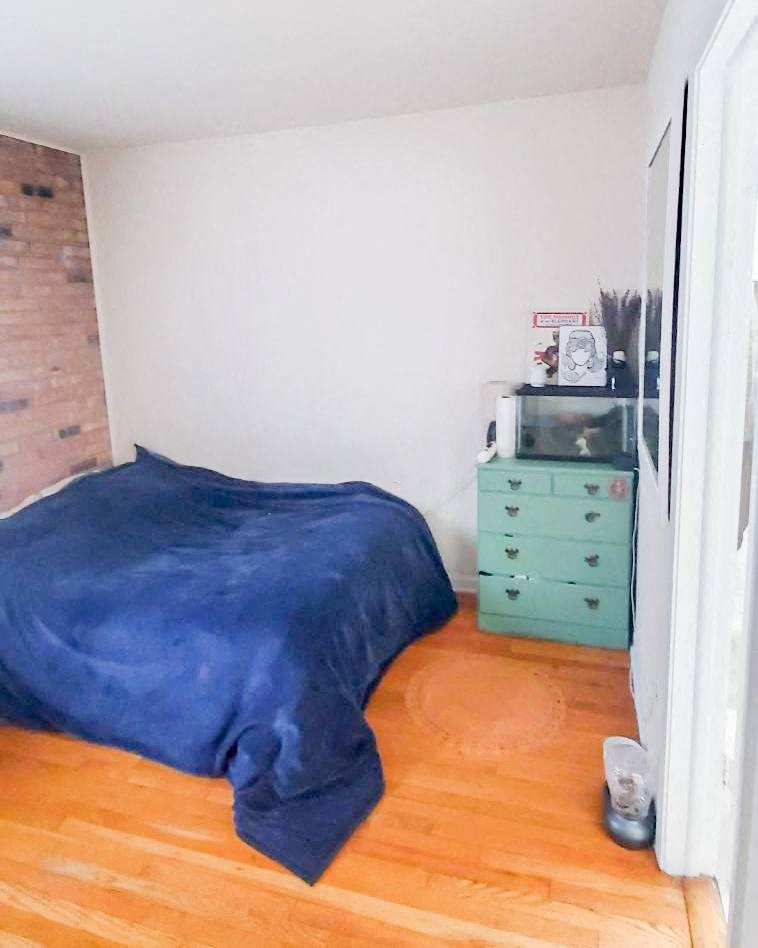 a bedroom with a bed and a dresser in it