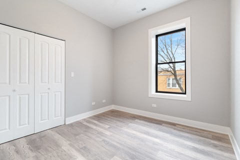 an empty room with white walls and a window