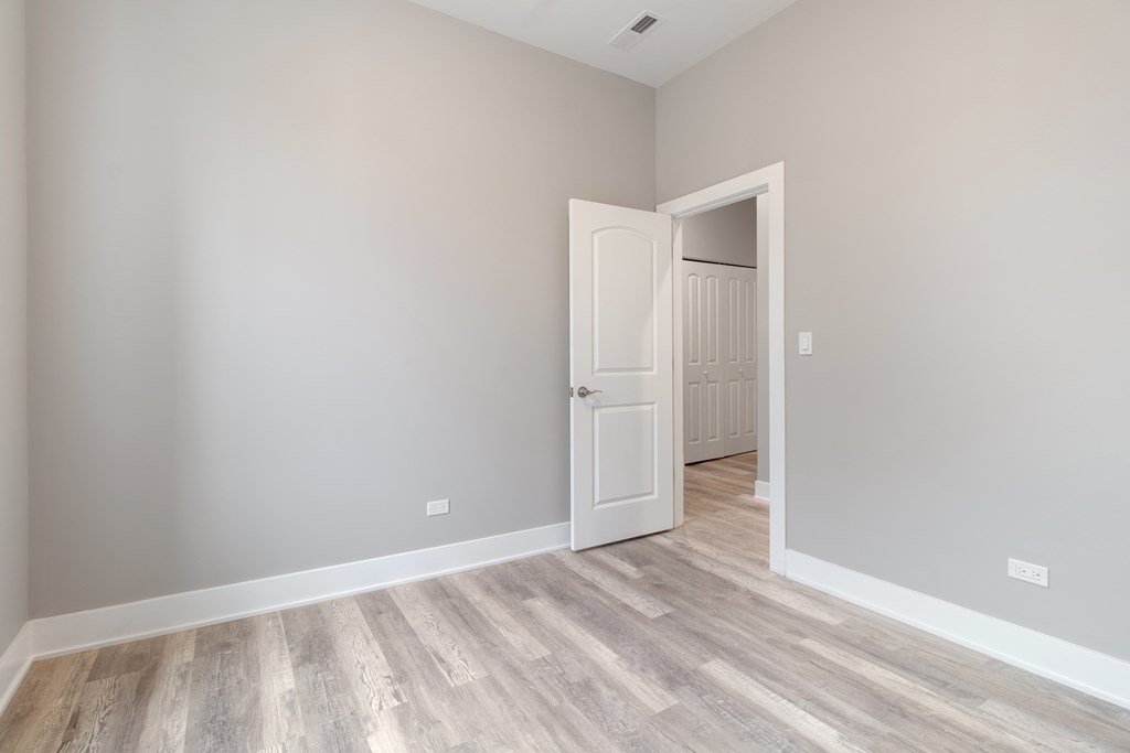 an empty room with a door and a hallway