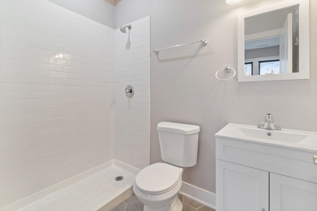 a white bathroom with a toilet and a sink
