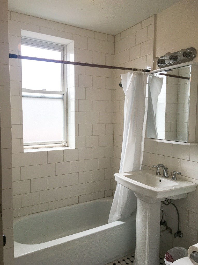 a small bathroom with a sink and a bath tub