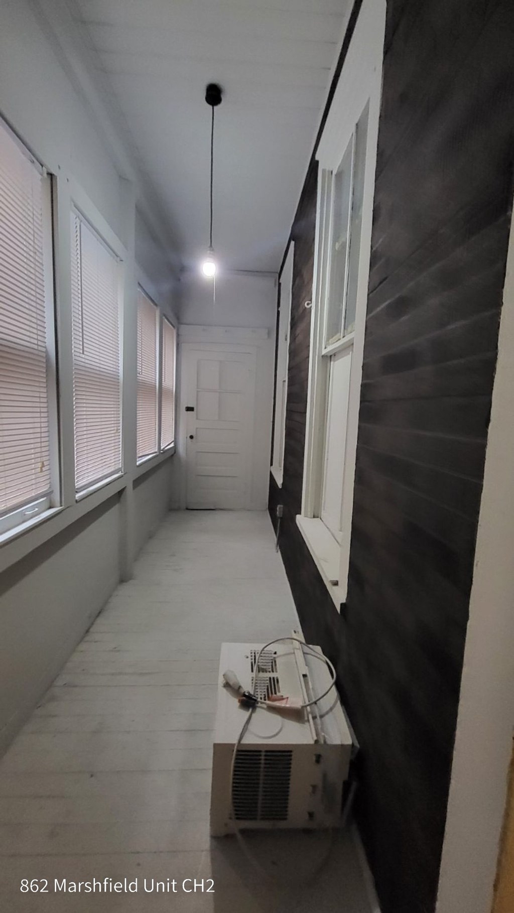 A long hallway with a unit in the corner.