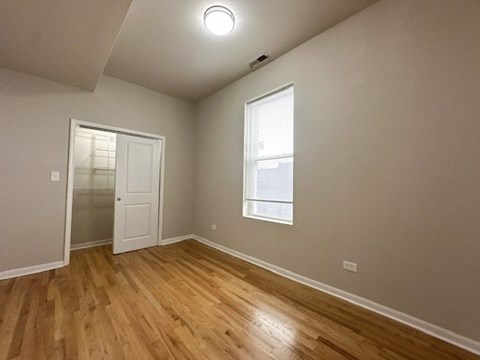 A room with wooden floors and a window.