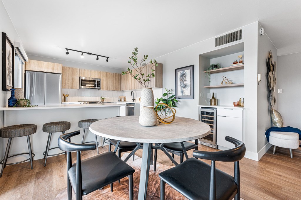a kitchen and dining area with a table, chairs, and lots of storage