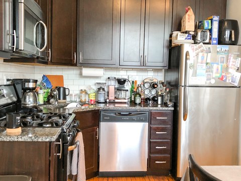 a small kitchen with a stove and a refrigerator