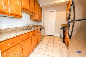 a kitchen with wood cabinets and granite countertops