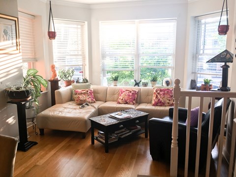 A living room with a white couch and a coffee table.