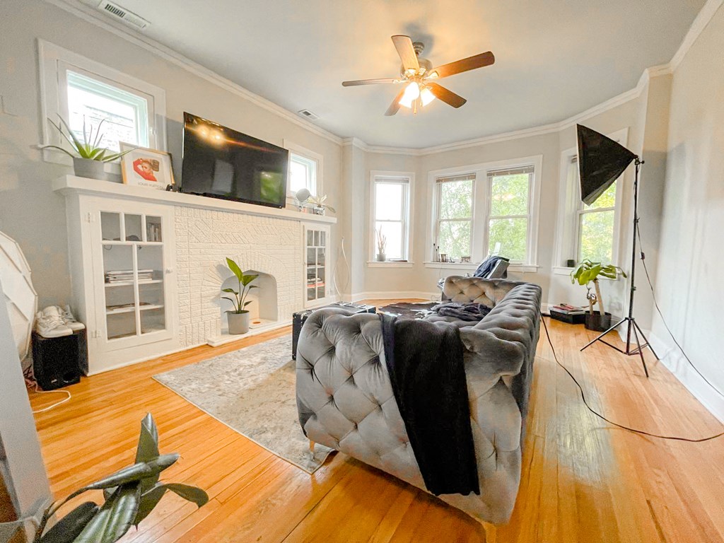 a living room with a couch and a ceiling fan