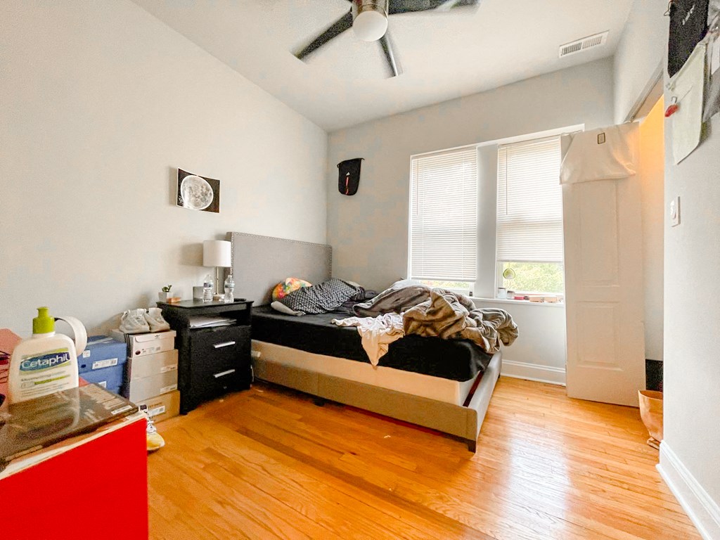 a bedroom with a bed and a dresser and a window