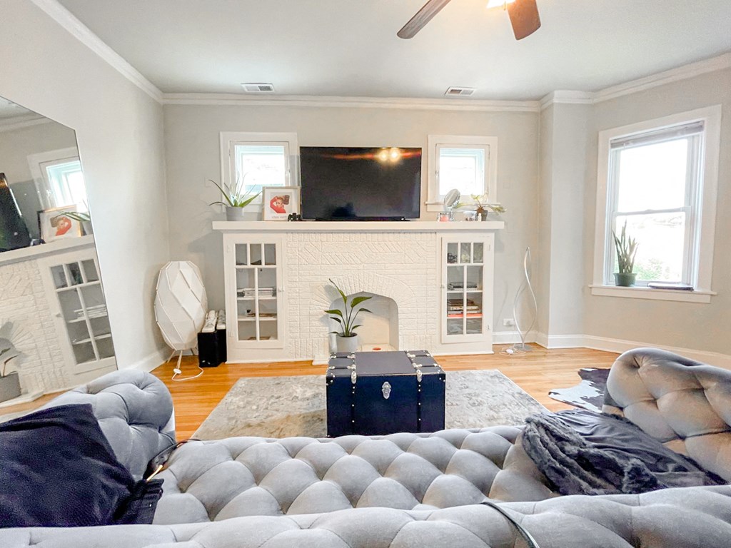 a living room with a couch and a fireplace and a tv
