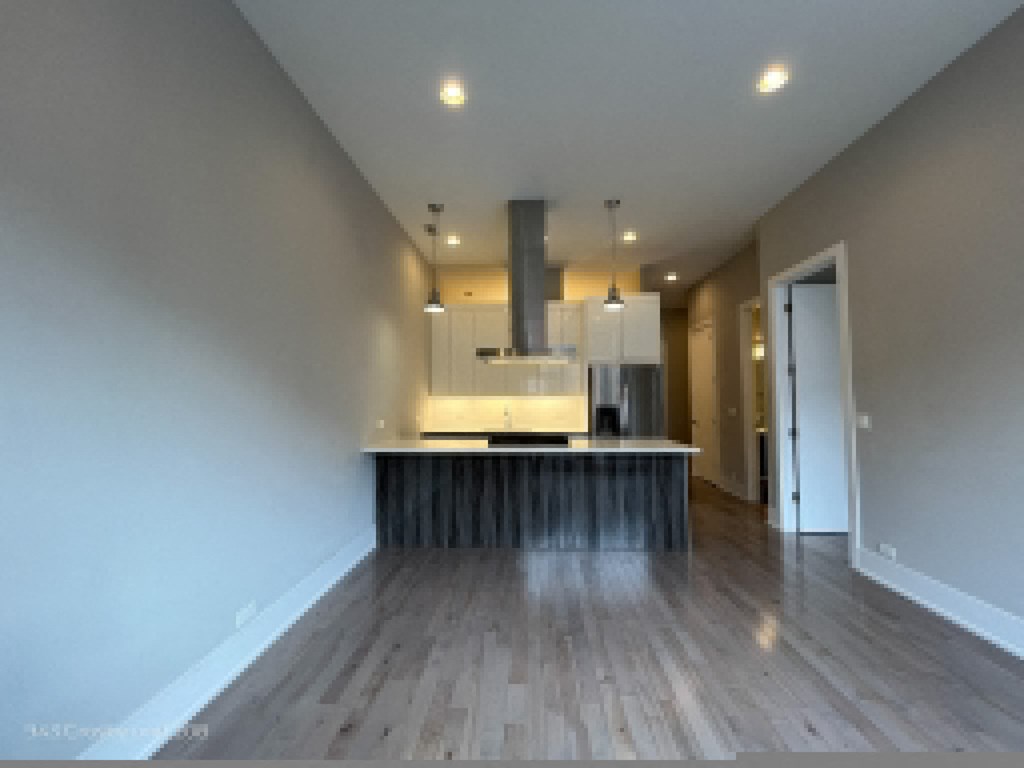 an open kitchen and living room with a large island