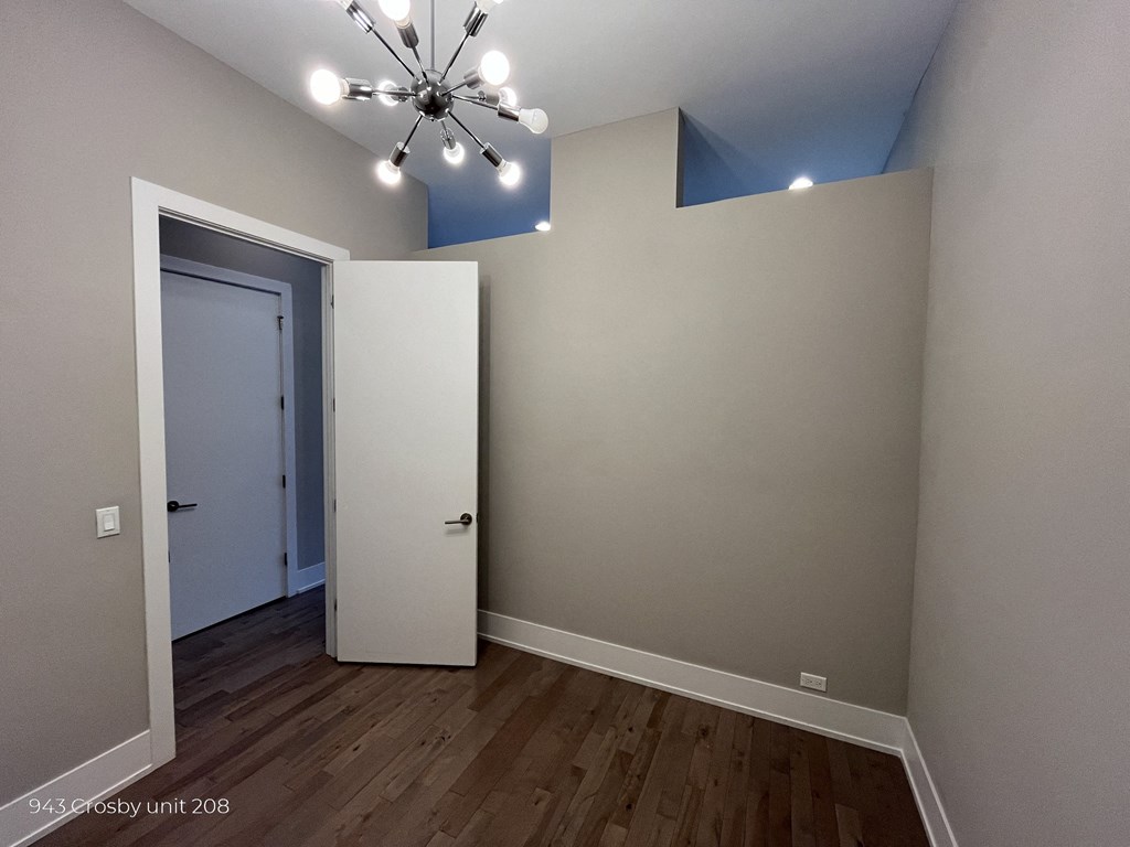 a bedroom with a closet and a door to the bathroom