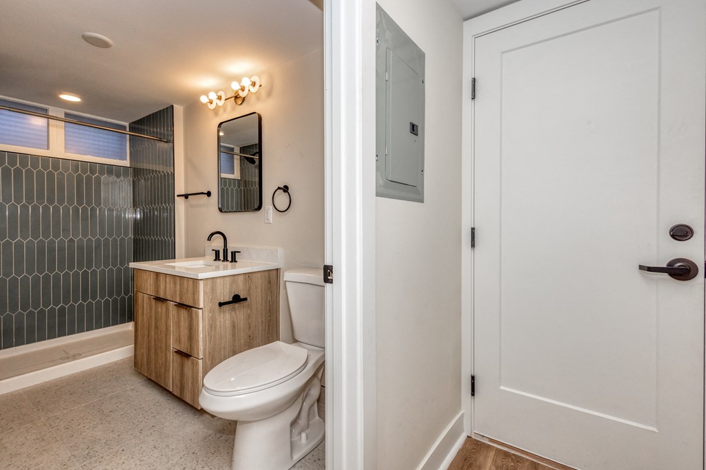 a bathroom with a toilet and a sink and a shower