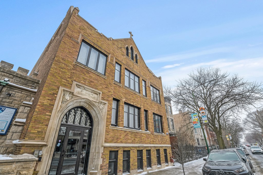 a brick building with a car parked in front of it