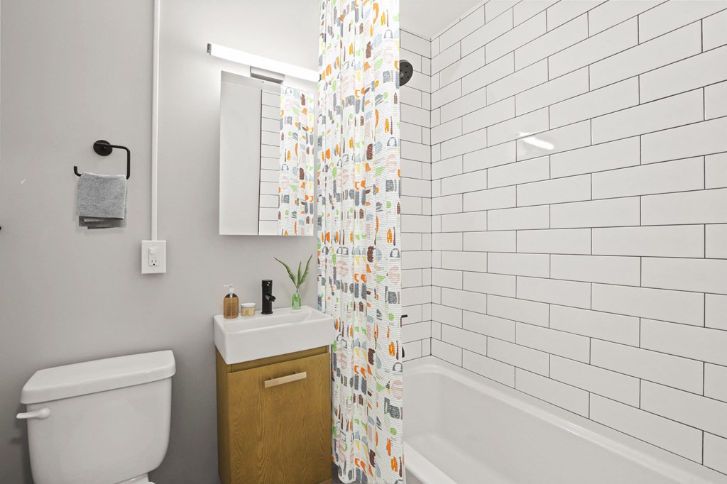 a white bathroom with a shower curtain and a toilet