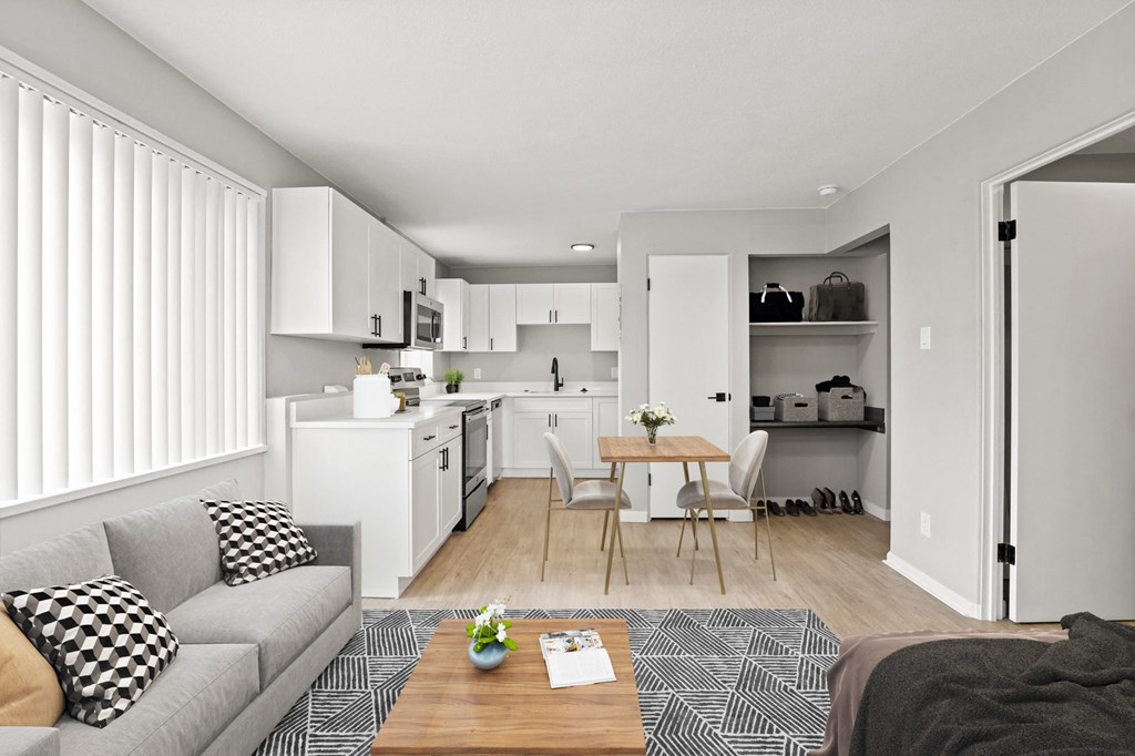 a living room and kitchen with a couch and a table