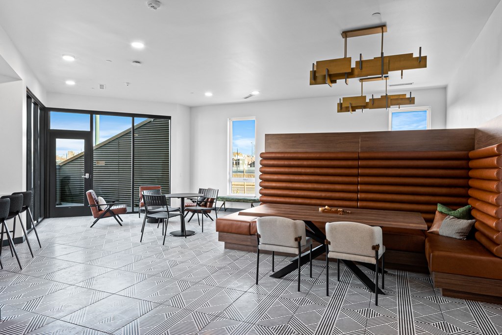A modern dining room with a wooden table and chairs.