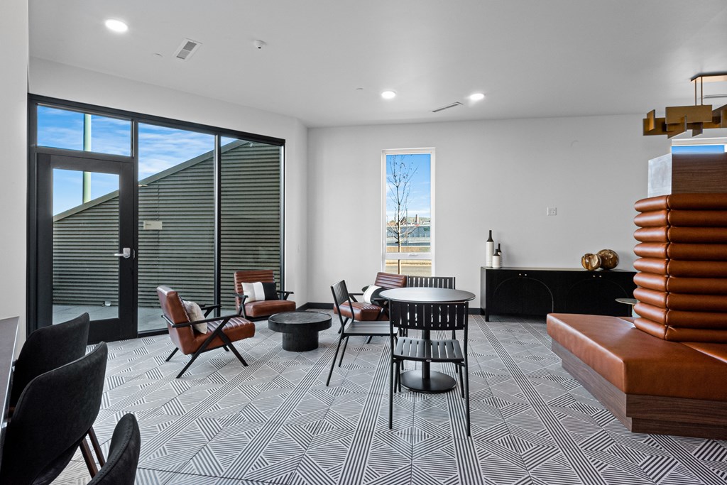 A modern living room with a black and white patterned carpet.