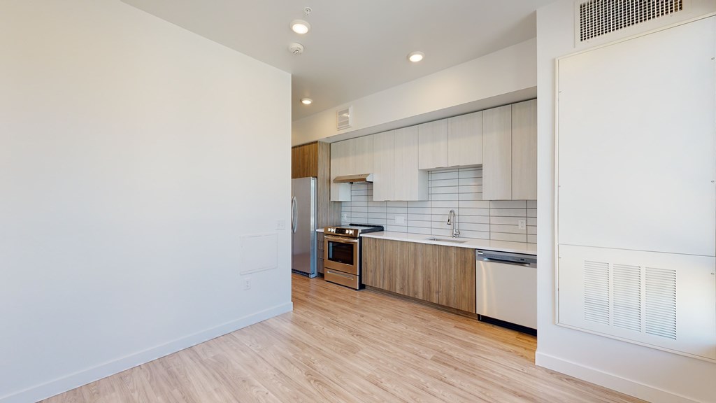 A kitchen with white cabinets and a wooden island.
