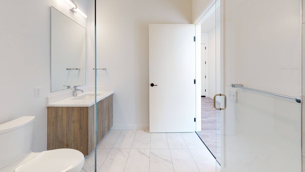 A white bathroom with a toilet, sink, and bathtub.