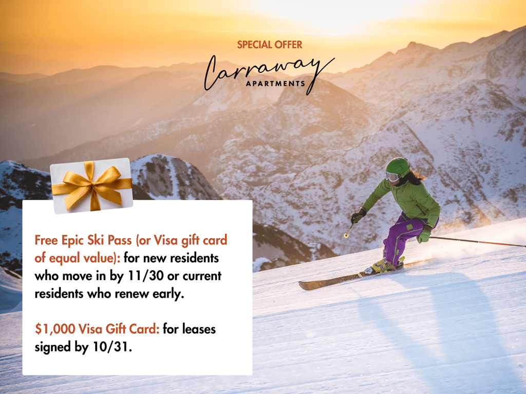 A person skiing on a snowy mountain with a sunset in the background.