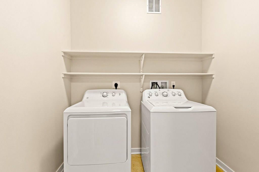 a washer and dryer in a laundry room with white appliances