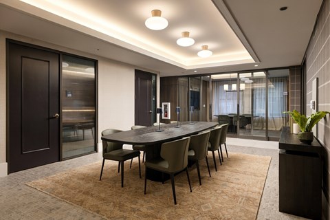 A modern dining room with a large table and chairs.