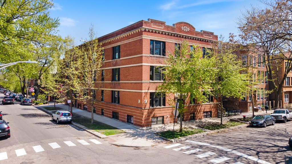 a red brick building on the corner of a city street