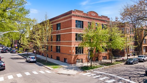 a red brick building on the corner of a city street