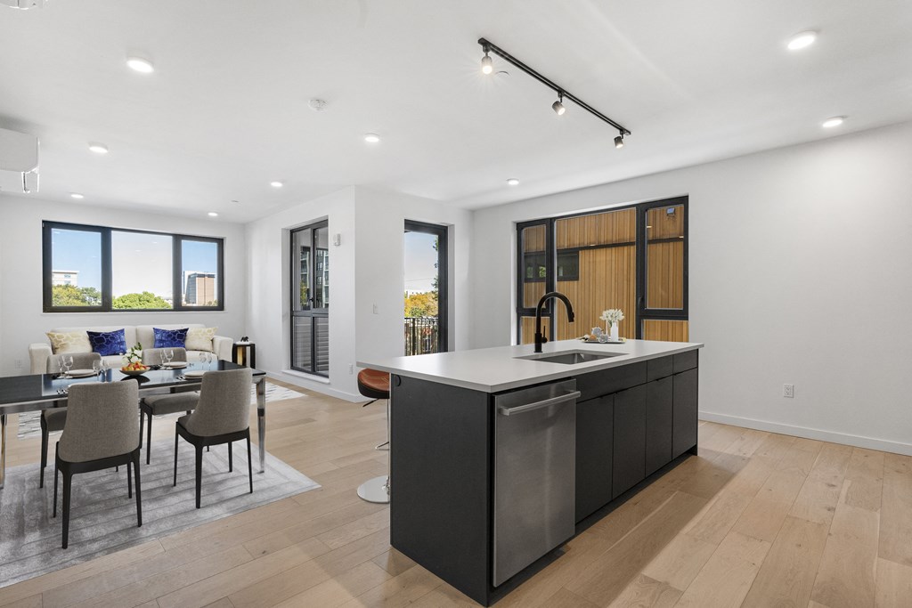 a living room with a kitchen and a dining room