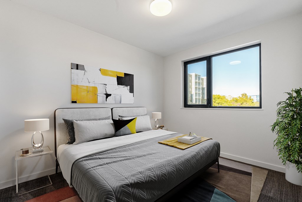 a bedroom with a large bed and a large window