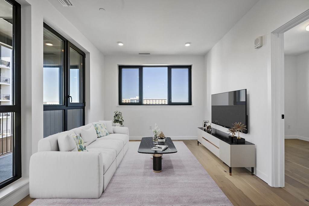 a living room with a white couch and a coffee table