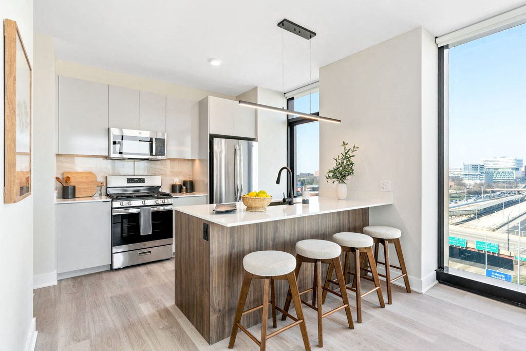 a kitchen with a large island and bar stools