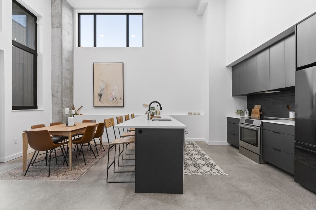 a kitchen and dining area with a table and chairs