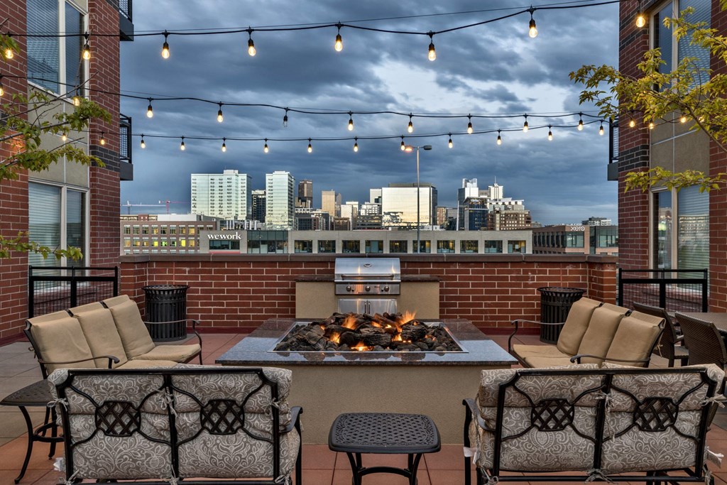 a patio with a fireplace and a view of the city